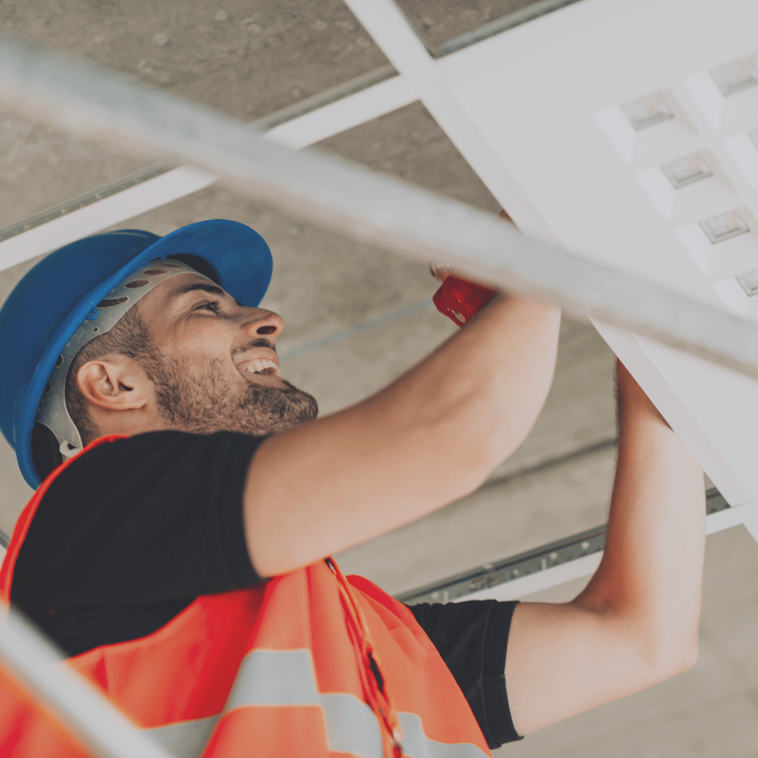 Worker conducting preventative maintenance inside a facility.