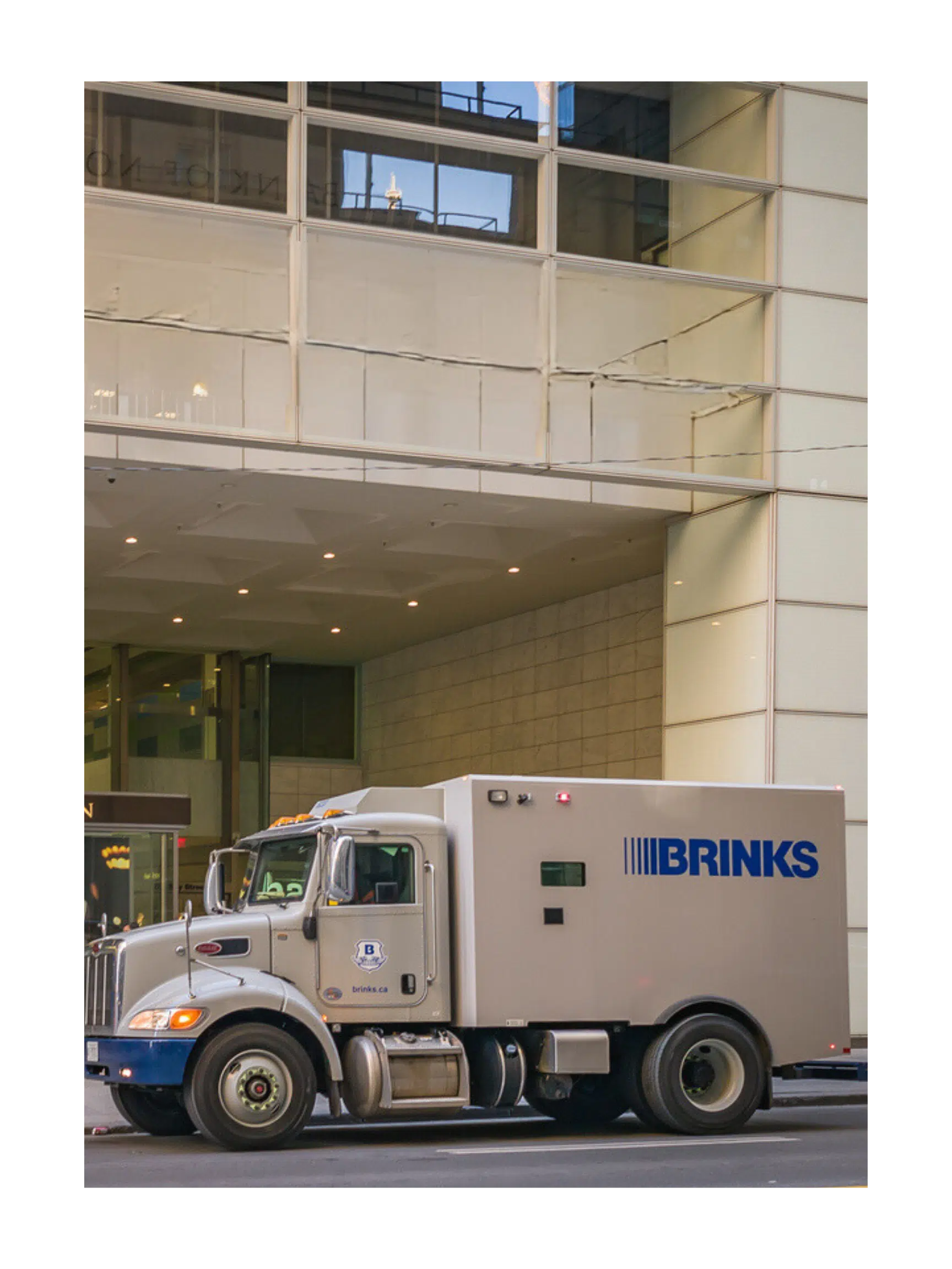 a security truck picking up a branch bag from a bank